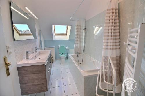 a bathroom with a sink and a toilet and a shower at Maison six in Pléneuf-Val-André