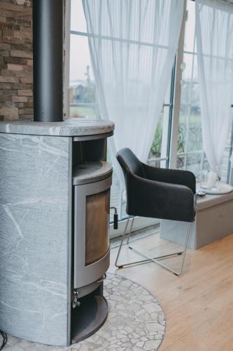 a wood stove in a living room with a chair at Bungalow mit Basketballplatz in Lemgo