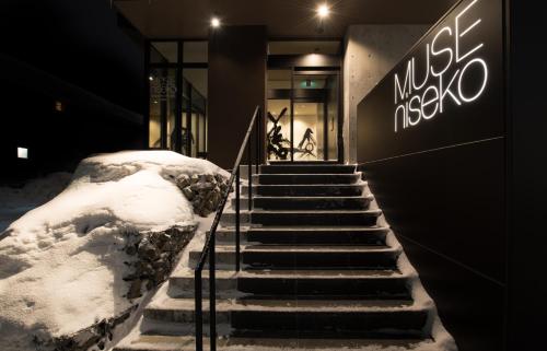 a set of stairs in front of a building with snow at MUSE Niseko in Kutchan