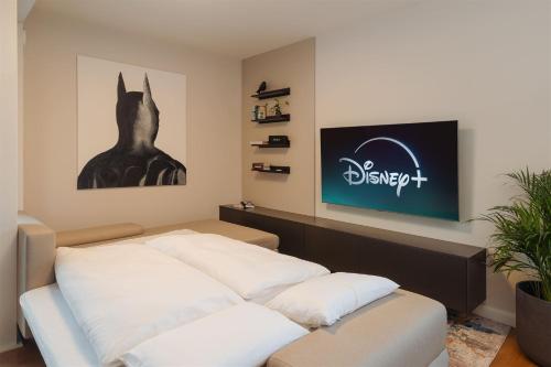 a room with a bed with a sign on the wall at Luxury Sunny Home - Free Garage, Metro, Balcony, PS5, 2nd parking on request in Prague