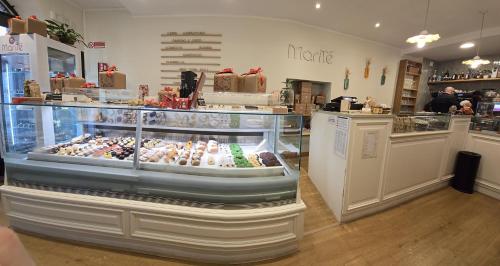 a display case in a bakery with many different pastries at Il Palazzetto in Bolsena