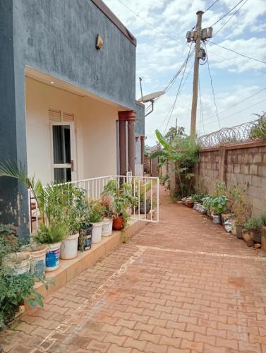 a courtyard of a house with potted plants at Royal Stay in Kira