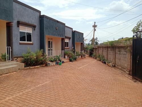 a brick parking lot in front of a house at Royal Stay in Kira