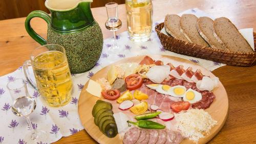 a plate of food with eggs meat and vegetables on a table at Hotel Gabriel in Keutschach am See