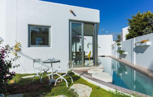 a house with a pool and a table and chairs at Villa Italy in Playa d'en Bossa