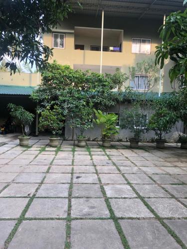 a courtyard with potted plants in front of a building at Hotel Paradiso, in Unawatuna