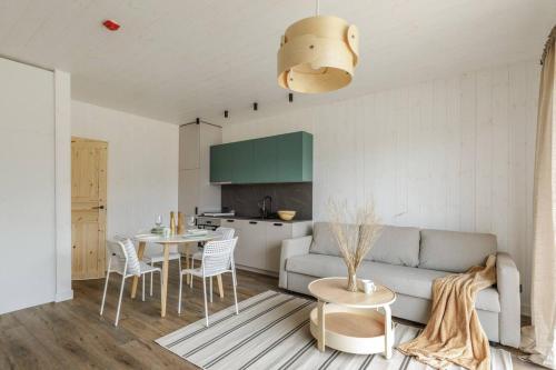 a living room with a couch and a table at Svencelės burė 5 in Svenele