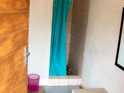 a door with a blue curtain in a room at Shik Shack Backpackers in Guernsey Nature Reserve