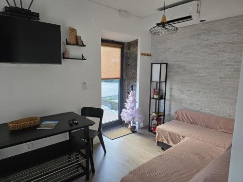 a living room with a couch and a christmas tree at Salmoura's Place AL 4724 in Santa Cruz das Flores