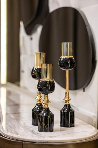 two wine glasses on a table in front of a mirror at شقة فندقية دوبلكس القاهرة الدقي in Cairo