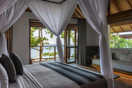 Ein Bett oder Betten in einem Zimmer der Unterkunft Jeeva Santai Villas