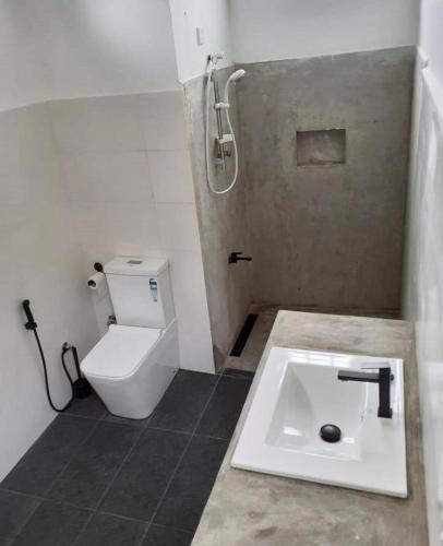 a bathroom with a toilet and a sink at The Kandy House ~ Exclusive Villa in Kandy