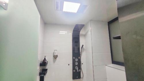 a bathroom with a shower with a sink and a mirror at A&G Apartment in Zhangjiajie
