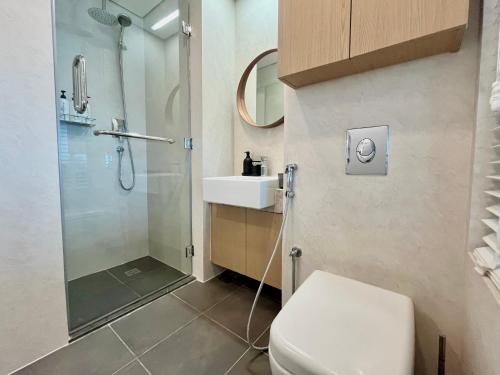 a bathroom with a shower and a toilet and a sink at Boutique Studio in Palm Jumeirah - Stunning View in Dubai