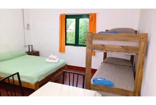 une chambre avec deux lits superposés et une fenêtre dans l'établissement Hospedaje Los Quebrachos, à San Marcos Sierras
