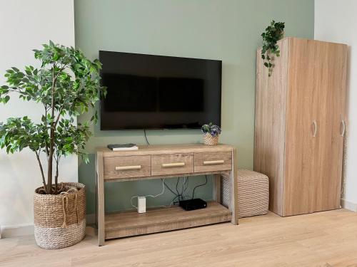 a wooden entertainment center with a television on a wall at Boutique Studio in Palm Jumeirah - Stunning View in Dubai