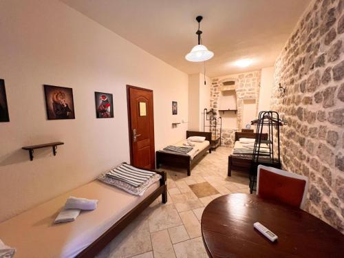 a living room with a table and a couch at Old Town Homestel in Kotor