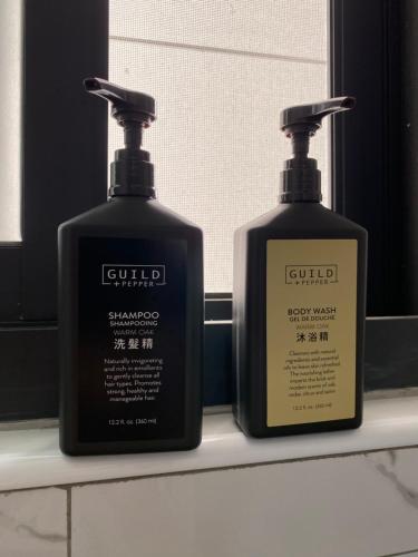 two bottles of soap on a shelf in a bathroom at 藏品民宿 埔里包棟10人 in Nantou City