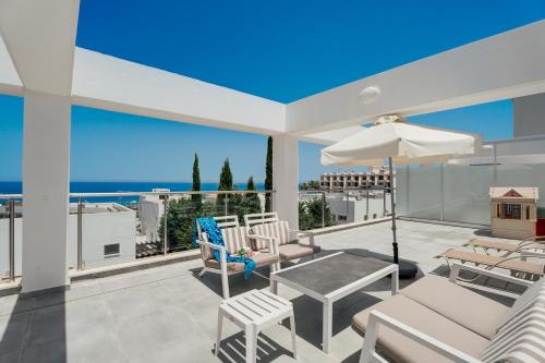 a house with a balcony with a view of the ocean at Seafront Protaras Apartments in Protaras