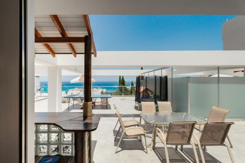 an open living room with a table and chairs at Seafront Protaras Apartments in Protaras