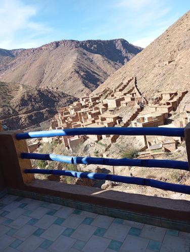 a bench sitting on top of a mountain overlooking a city at Atlas Pearl in Aguersioual