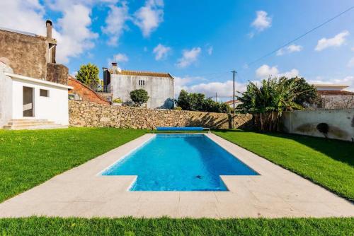a swimming pool in the yard of a house at Villa Donana in Beiriz