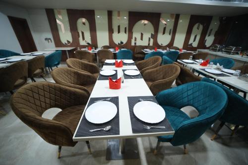 a dining room with a long table with plates and chairs at Hotel The RS Casa - Agra in Agra