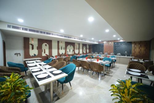 a restaurant with tables and chairs in a room at Hotel The RS Casa - Agra in Agra