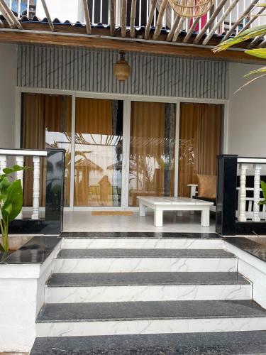 a lobby of a house with a table and benches at The Village Agonda in Agonda