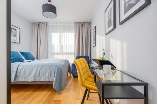 a bedroom with a bed and a desk and a glass table at Elegant Apartment in Warsaw with Parking and Desk for Remote Work by Noclegi Renters in Warsaw
