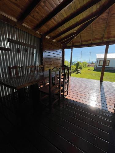 a wooden deck with a table and chairs on it at Patagonia Austral Suites in El Calafate