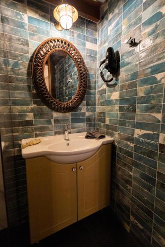 a bathroom with a sink and a mirror at April Medieval Hotel in Rhodes Town