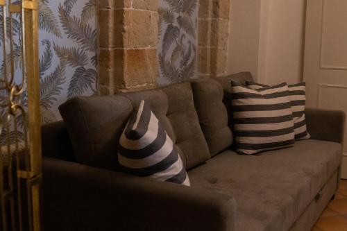 a couch with pillows on it in a living room at April Medieval Hotel in Rhodes Town