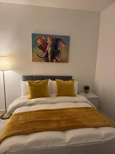 a bedroom with a bed with a painting of an elephant at Cozy 3-Bedroom Home Perfect for Work & Leisure in Birmingham