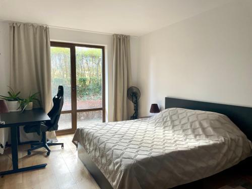a bedroom with a bed and a desk and a window at Ground floor 2-bedrooms, 2-bathrooms apartment near Bansko in a complex with pools and SPA included in Razlog
