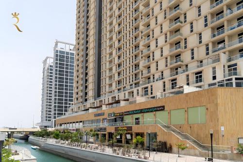 a large building next to a river with buildings at Elegant Reem Atelier - 2BR Urban Escape in Abu Dhabi