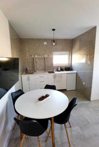 a white table and chairs in a kitchen at Vila Nika in Banja Luka