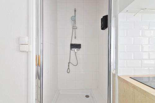 une douche avec pommeau de douche dans une salle de bain dans l'établissement Studio Quartier Tour Eiffel 9 Free Netflix, à Paris