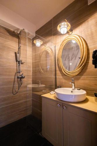 a bathroom with a sink and a mirror at April Medieval Hotel in Rhodes Town