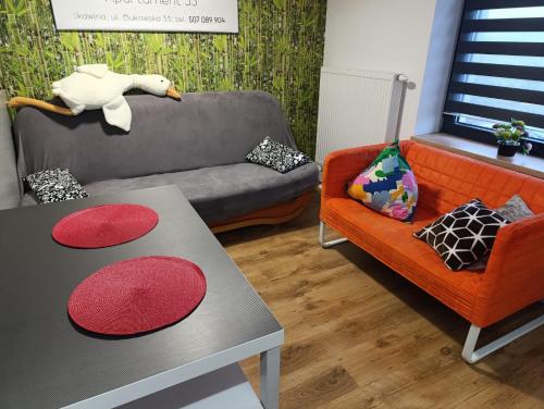 a living room with a couch and a table at Apartament 33 Skawina in Skawina