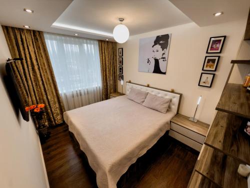 Ένα ή περισσότερα κρεβάτια σε δωμάτιο στο Apartment in Călărași