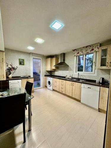 a large kitchen with a table and a stove at Villa Martina in Cambrils