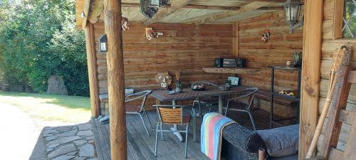 a wooden cabin with a table and chairs in it at The White Cabin in Tauranga