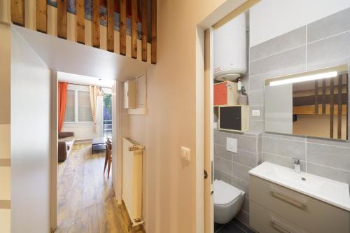 a bathroom with a white toilet and a sink at Ô Cocon - Station de ski à pied vue montagne in Eaux-Bonnes