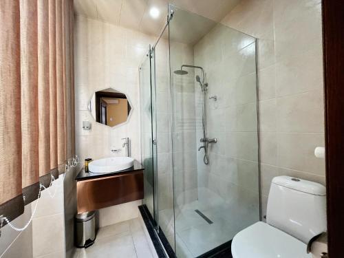 a bathroom with a shower and a toilet and a sink at Phazisi Hotel in Tbilisi City