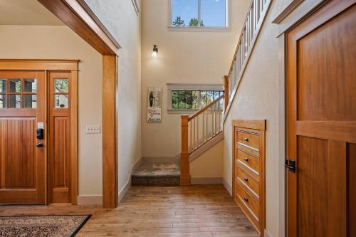 a hallway with a wooden door and stairs at Awbrey in Bend