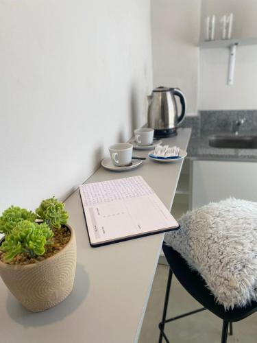 a kitchen counter with a desk with a plant on it at ALWA Suites in Resistencia