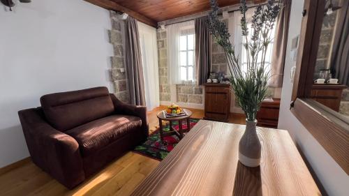 a living room with a leather chair and a table at Stara Čaršija Hotel & SPA in Bar