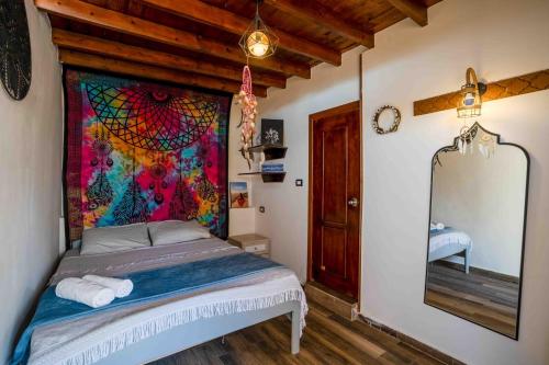 a bedroom with a bed with a painting on the wall at Dream Catcher in Dahab