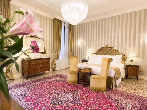 a bedroom with a large bed and a large pink flower at Hotel Ai Cavalieri di Venezia in Venice